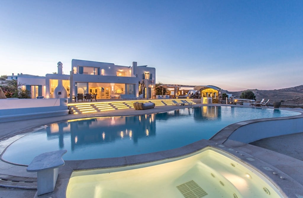 Villa and pool lit at dusk at Villa Splendida in Kalafatis, Mykonos