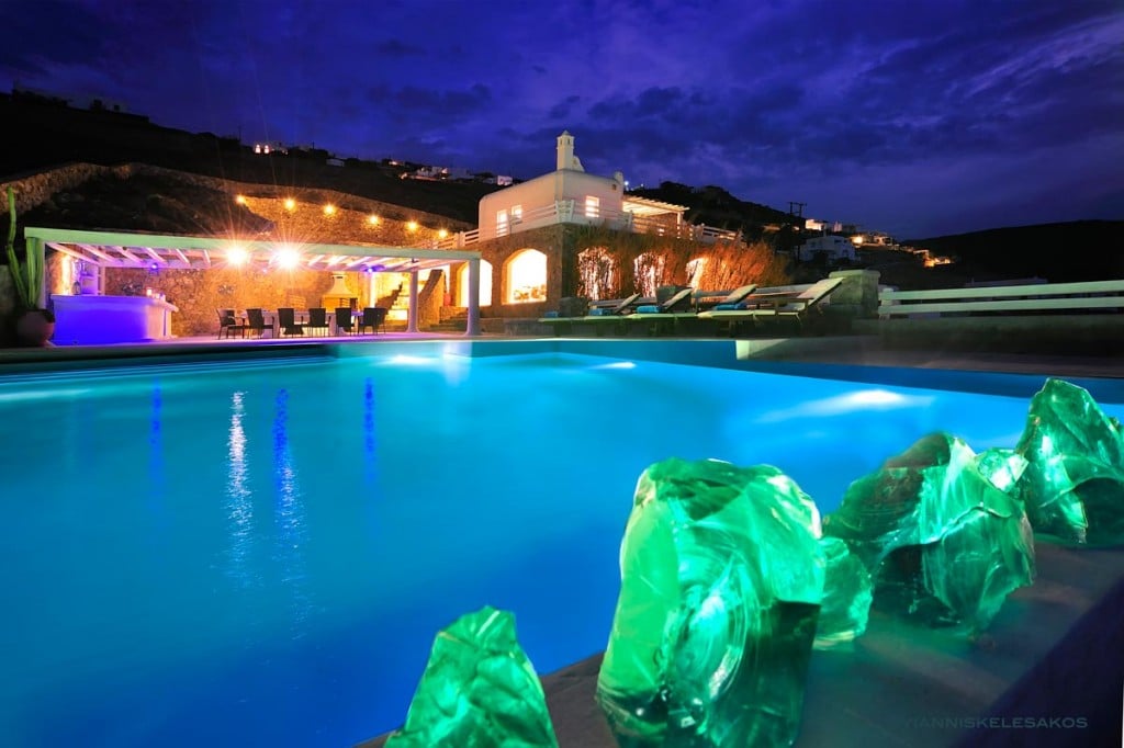 Lit pool and villa at night at Villa Artemis in Choulakia, Mykonos