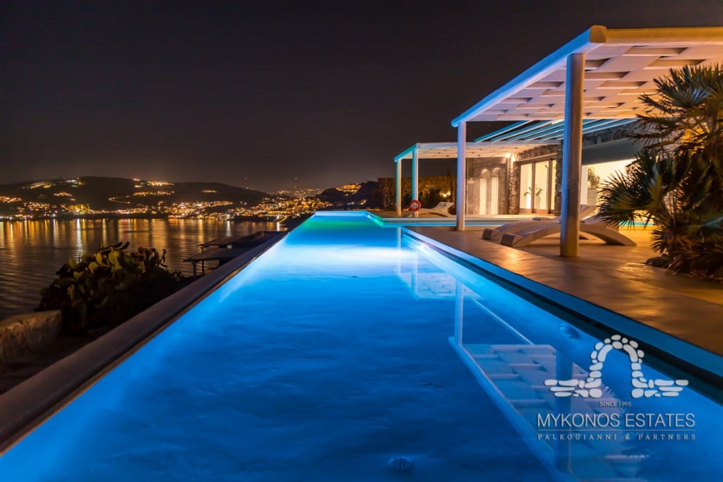 Long infinity pool at night at Villa Diamond in Aleomandra, Mykonos