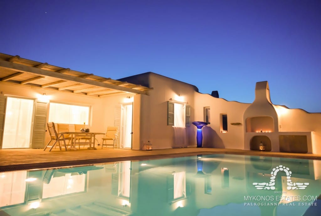 Infinity pool and terrace at dusk at Villa ME 8375, for sale in Kalafatis, Mykonos