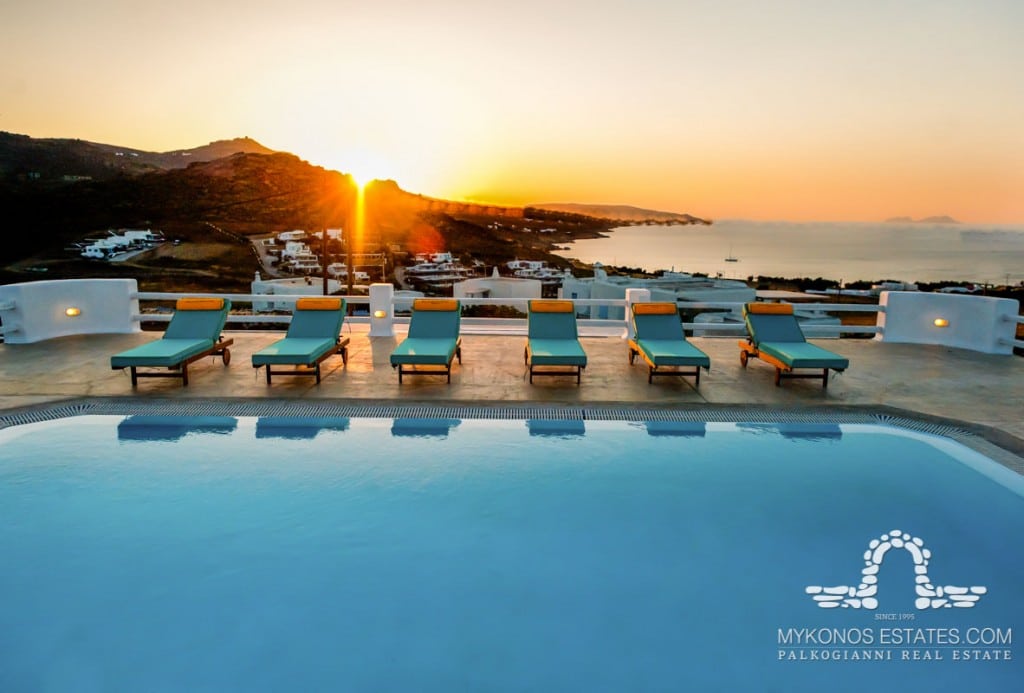 Pool and loungers at sunset at Anatolia Villas, rental villa in Kalafatis, Mykonos