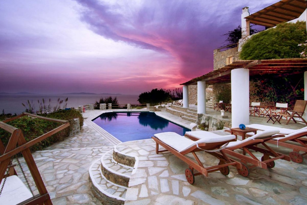 Pool terrace under a stormy sunset at Villa Cindy in Choulakia, Mykonos