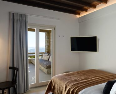 Double bedroom with sea-view balcony at Villa Alabaster, Kounoupas, Mykonos