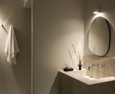 Bathroom vanity with round mirror at Villa Sunstone, Kounoupas, Mykonos