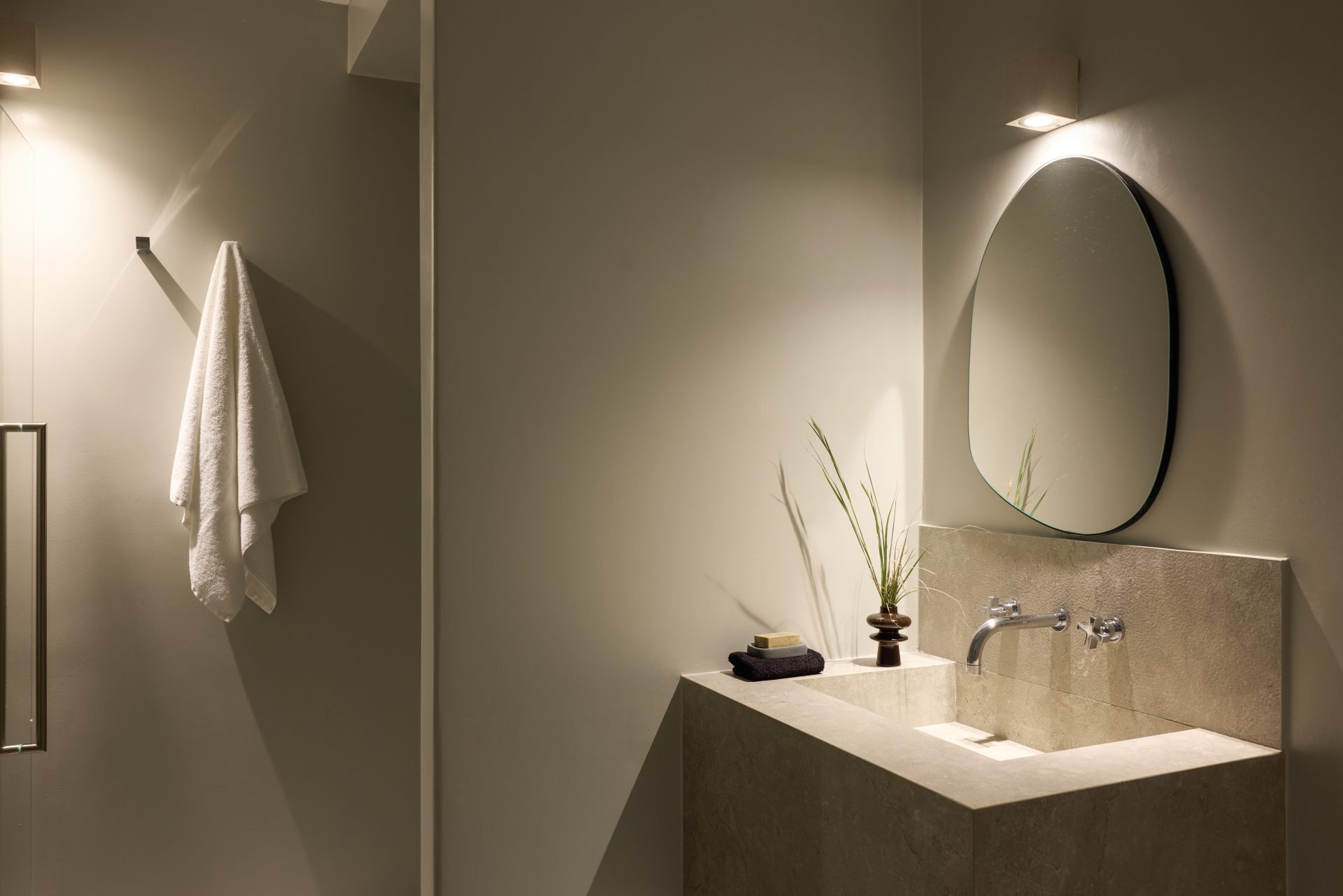Bathroom vanity with round mirror at Villa Sunstone, Kounoupas, Mykonos