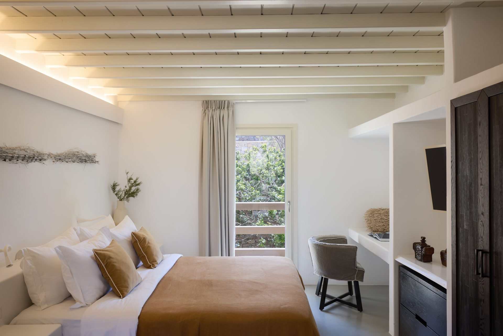 Double bedroom with garden-view window at Villa Sunstone, Kounoupas, Mykonos