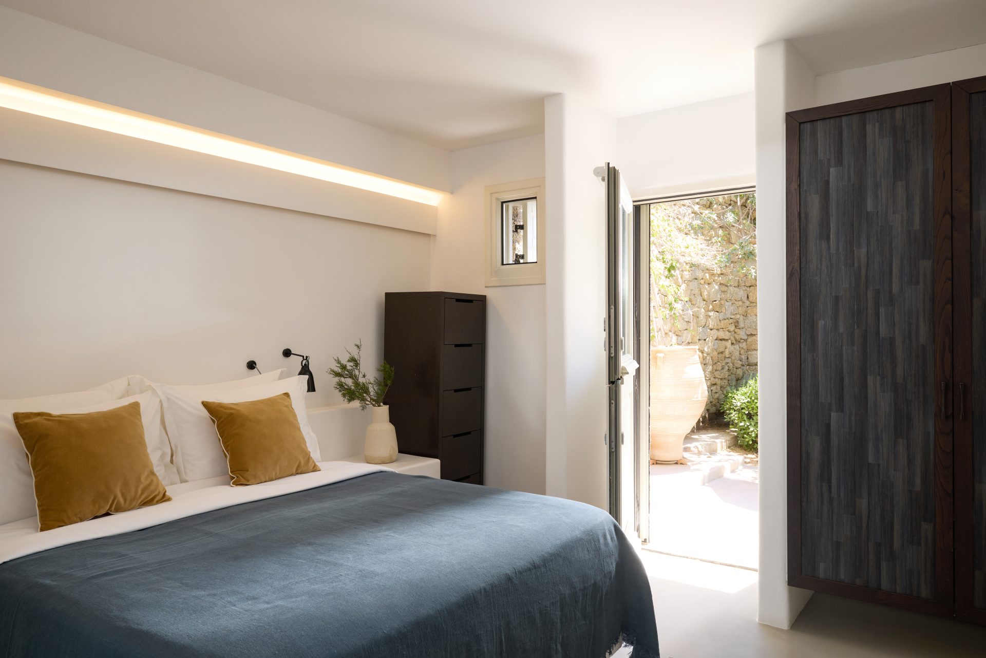 Master bedroom with sea-view terrace access at Villa Sunstone, Kounoupas, Mykonos