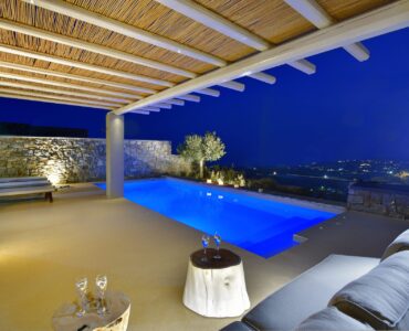 Illuminated pool and lounge at night at Villa Amethyst, Kounoupas, Mykonos