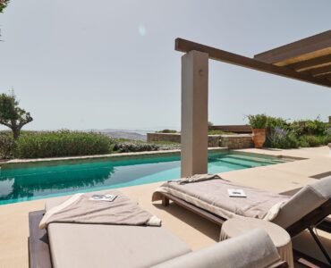 Pool terrace with daybeds at Villa Amethyst, Kounoupas, Mykonos