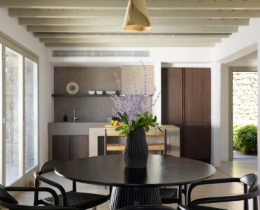 Dining table and kitchen area at Villa Ammolite, Kounoupas, Mykonos