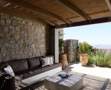 Shaded outdoor lounge with sea view at Villa Ammolite, Kounoupas, Mykonos