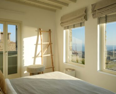 Bright bedroom with sea-view windows at Villa Moonstone, Kounoupas, Mykonos