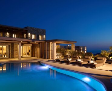 Illuminated pool at dusk at Villa Moonstone, Kounoupas, Mykonos