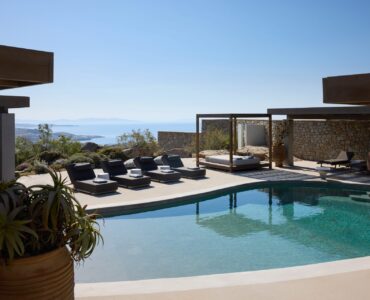 Pool deck with sun loungers and sea view at Villa Moonstone, Kounoupas, Mykonos