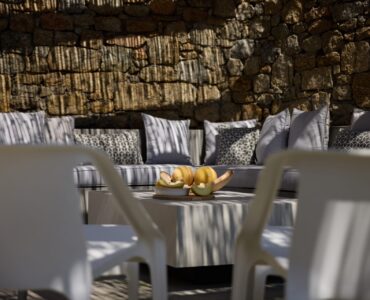 Shaded outdoor lounge and dining area at Villa Moonstone, Kounoupas, Mykonos