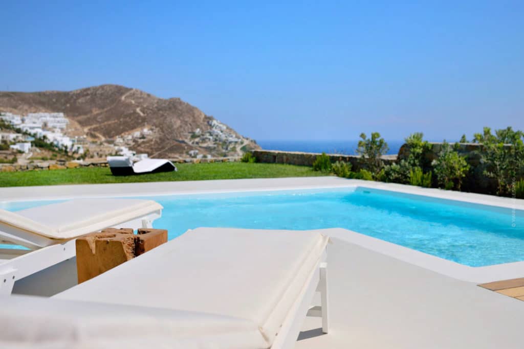 Pool terrace with hillside and sea view at Villa Erato in Elia, Mykonos