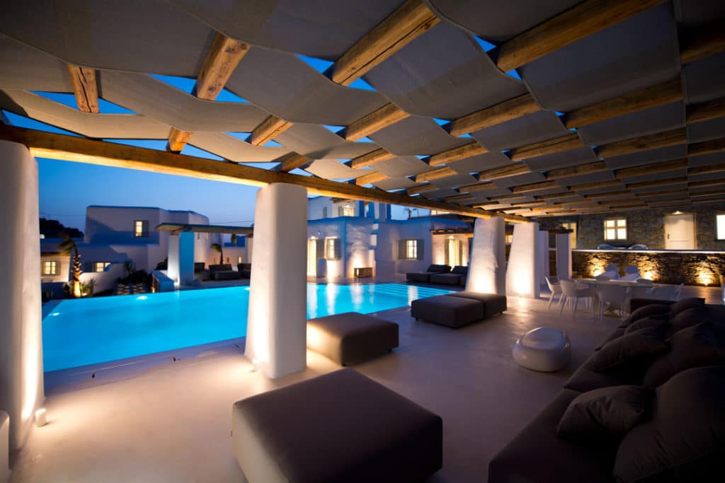 Lit pergola lounge beside the pool at night at Villa Opalia in Agia Sofia, Mykonos