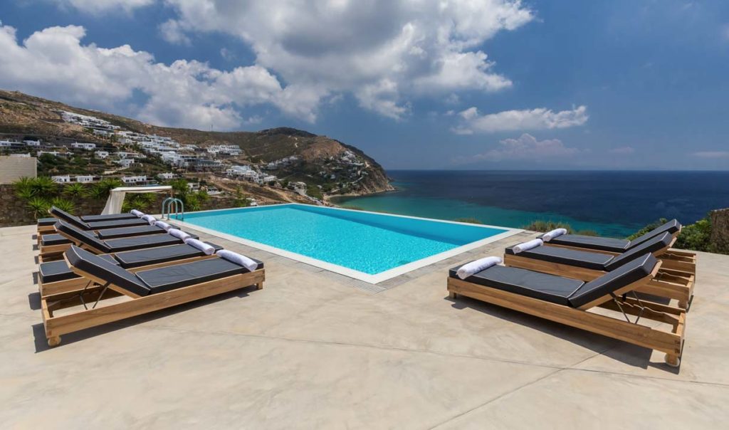 Pool with sunbeds and sea view at Villa Magia in Elia, Mykonos