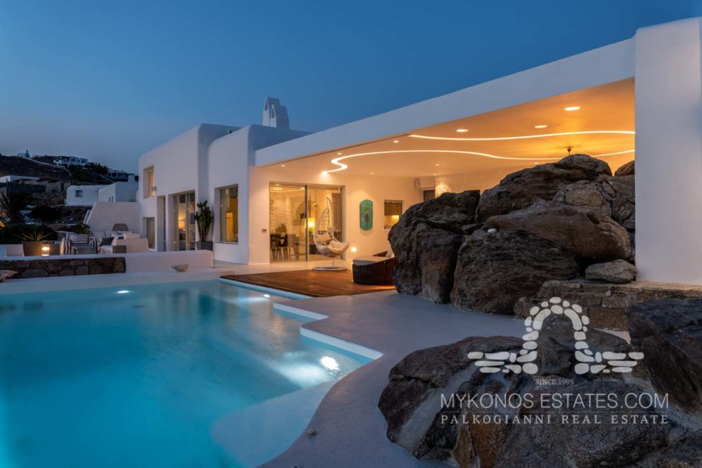 Pool and lit terrace at dusk at Villa Marin in Agios Ioannis, Mykonos
