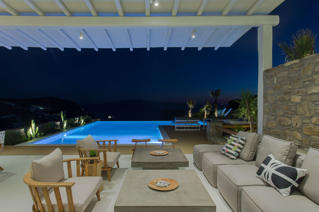 Covered lounge and pool at night at Villa Althea in Elia, Mykonos