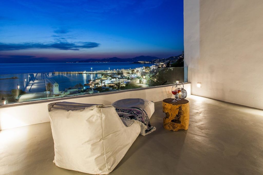 Terrace bean bag at dusk overlooking the lights of Mykonos Town harbour from Villa Davian