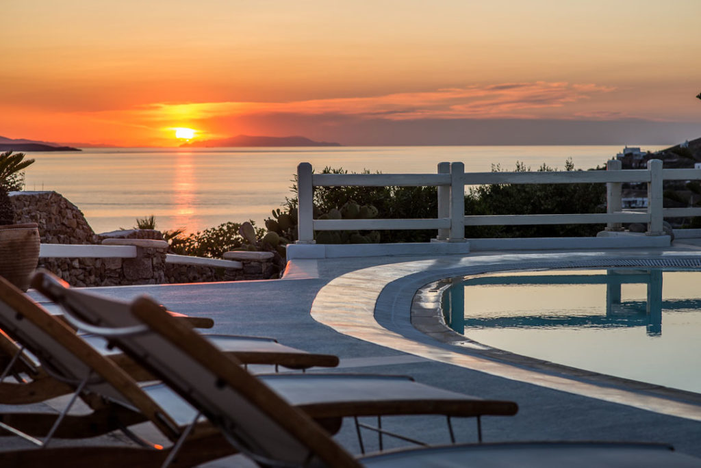 Sunset over the sea from the pool terrace at Villa Alia, for sale in Agios Ioannis, Mykonos