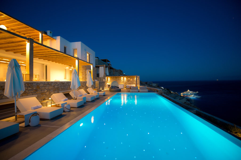 Illuminated infinity pool and terraces of Villa Harmony at night, Agios Lazaros, Mykonos