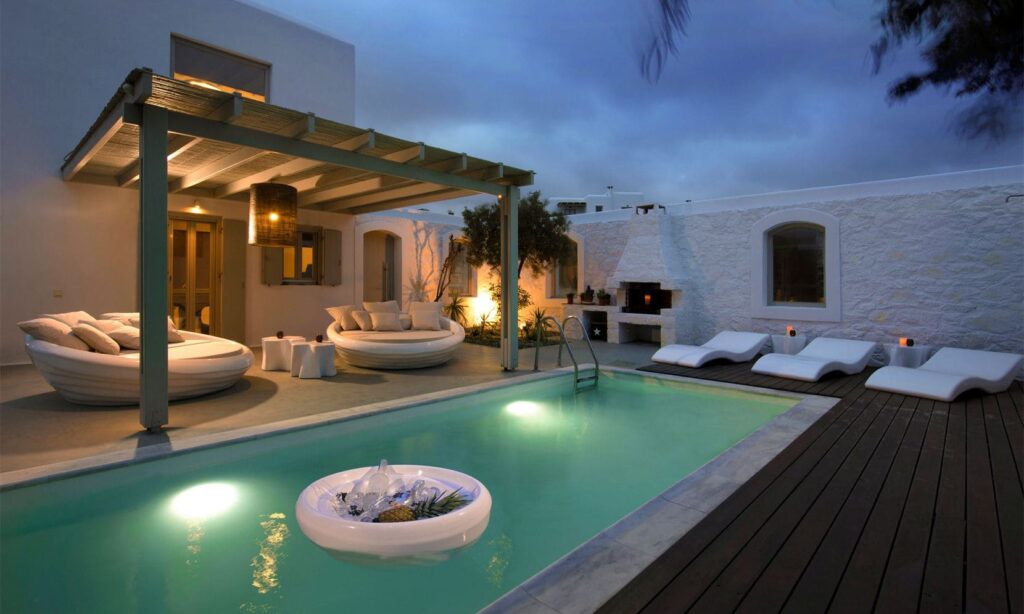 Lit pool and pergola at dusk at Villa Amalan in Kalafatis, Mykonos