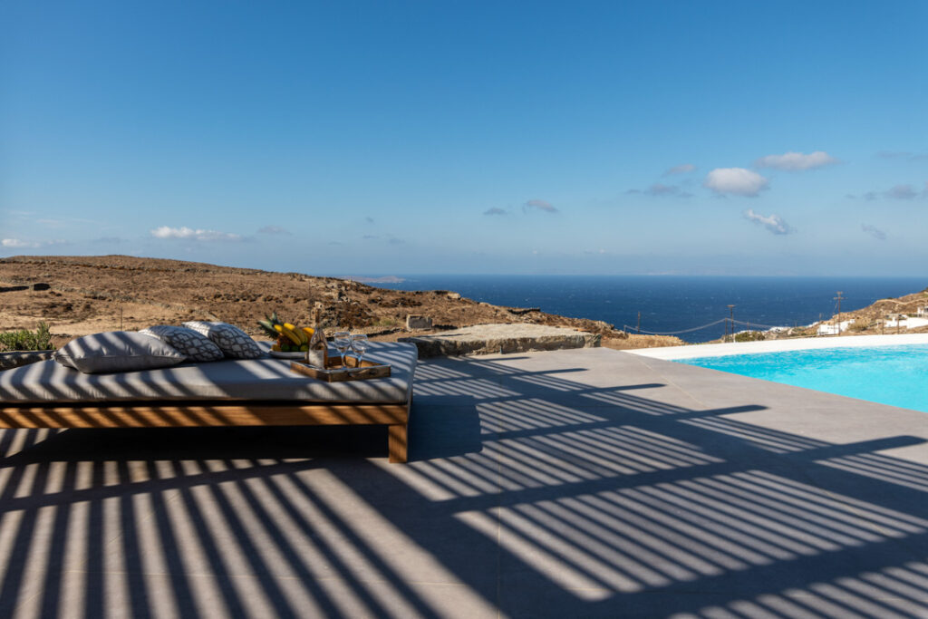 Sun terrace with loungers overlooking the sea at Villa Apollonia, for sale in Agios Lazaros, Mykonos