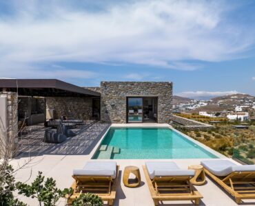 Private pool with sun loungers beside the stone-built villa at Aether Private Retreat - Grand Villa, Aleomandra, Mykonos