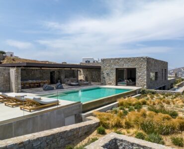 Private pool in front of the villa's stone façade at Aether Private Retreat - Grand Villa, Aleomandra, Mykonos