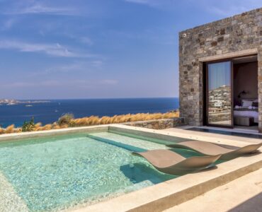 Infinity pool with sun deck and loungers overlooking the Aegean Sea at Aether Private Retreat - Grand Villa, Aleomandra, Mykonos