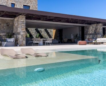 Infinity pool next to the covered stone terrace at Aether Private Retreat - Grand Villa, Aleomandra, Mykonos