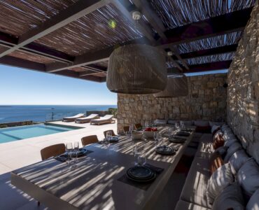 Covered outdoor dining area under a timber pergola at Aether Private Retreat - Grand Villa, Aleomandra, Mykonos