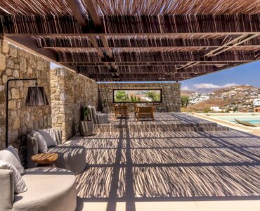 Stone terrace with timber pergola and sea views at Aether Private Retreat - Grand Villa, Aleomandra, Mykonos