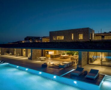Infinity pool lit at night beside the villa at Aether Private Retreat - Grand Villa, Aleomandra, Mykonos