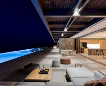 Covered outdoor lounge lit at night at Aether Private Retreat - Grand Villa, Aleomandra, Mykonos