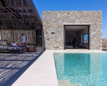Private pool in front of the villa's stone façade at Aether Private Retreat - Grand Villa, Aleomandra, Mykonos