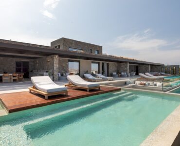 Infinity pool with sun deck and loungers overlooking the Aegean Sea at Aether Private Retreat - Grand Villa, Aleomandra, Mykonos