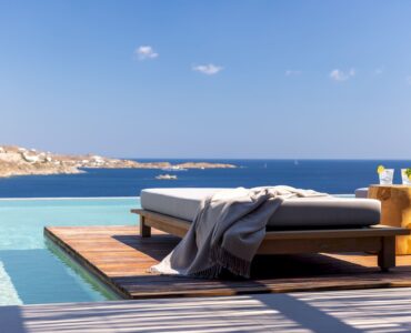 Infinity pool with sun deck and loungers overlooking the Aegean Sea at Aether Private Retreat - Grand Villa, Aleomandra, Mykonos