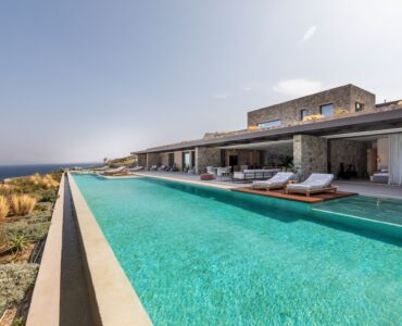 Long infinity pool stretching towards the sea and countryside at Aether Private Retreat - Grand Villa, Aleomandra, Mykonos