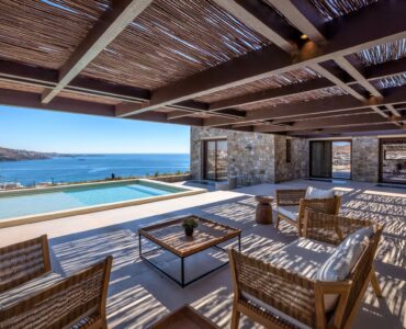Infinity pool next to the covered stone terrace at Aether Private Retreat - Grand Villa, Aleomandra, Mykonos