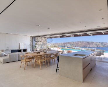 Open-plan living and dining area with floor-to-ceiling sea views at Aether Private Retreat - Grand Villa, Aleomandra, Mykonos