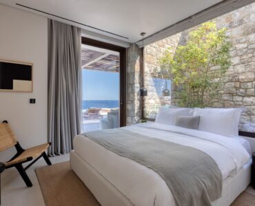 Bedroom with large window and sea view at Aether Private Retreat - Grand Villa, Aleomandra, Mykonos