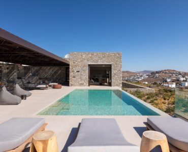 Private pool with sun loungers beside the stone-built villa at Aether Private Retreat - Grand Villa, Aleomandra, Mykonos