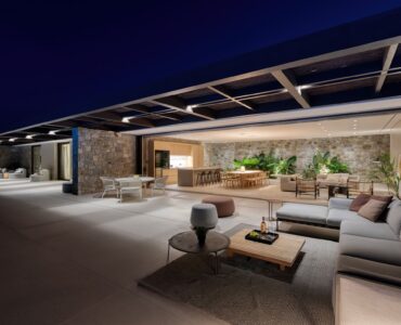 Covered outdoor lounge lit at night at Aether Private Retreat - Grand Villa, Aleomandra, Mykonos