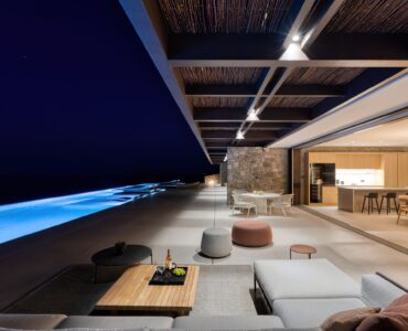 Covered outdoor lounge lit at night at Aether Private Retreat - Grand Villa, Aleomandra, Mykonos