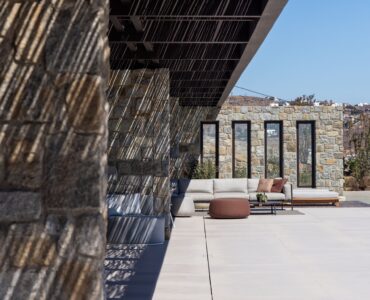 Stone terrace with timber pergola and sea views at Aether Private Retreat - Grand Villa, Aleomandra, Mykonos