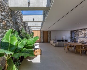 Living area with indoor planting and natural light at Aether Private Retreat - Grand Villa, Aleomandra, Mykonos