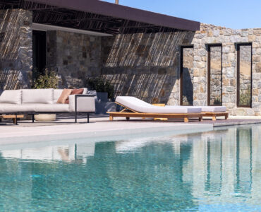 Pool terrace with shaded lounge area and sea views at Aether Private Retreat - Grand Villa, Aleomandra, Mykonos